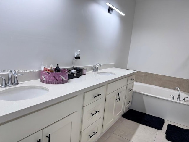 full bathroom with tile patterned floors, a bath, and double vanity