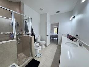 bathroom with toilet, a stall shower, vanity, and a bidet