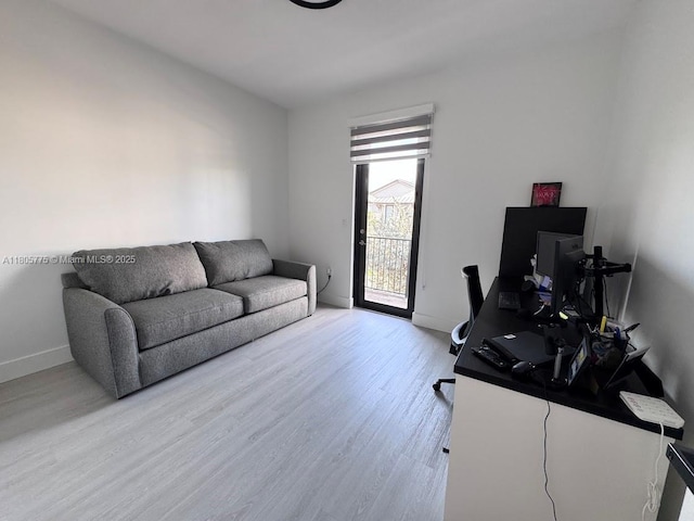 home office featuring light wood-type flooring and baseboards