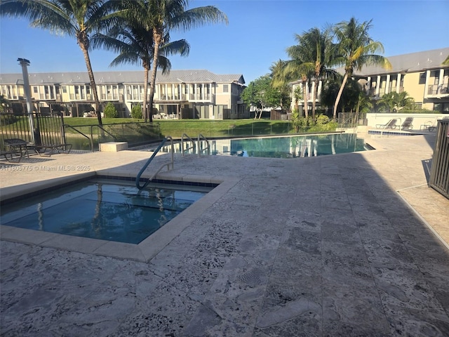 community pool featuring a patio and a residential view