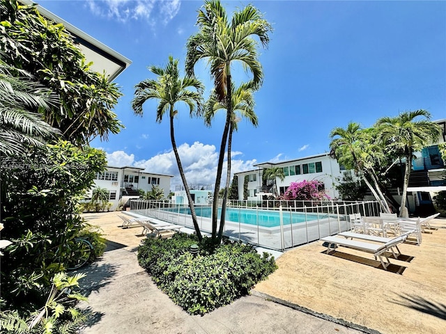 4710 Pine Tree Dr Unit 31, Miami Beach, FL 33140 - community pool with fence and a patio area
