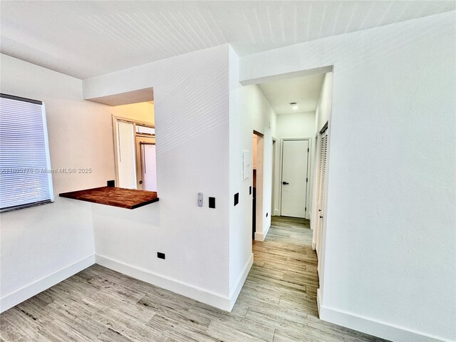 4710 Pine Tree Dr Unit 31, Miami Beach, FL 33140 - hallway with baseboards and light wood finished floors