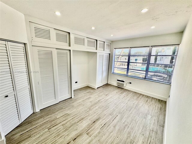 4710 Pine Tree Dr Unit 31, Miami Beach, FL 33140 - unfurnished bedroom featuring light wood finished floors, recessed lighting, and baseboards