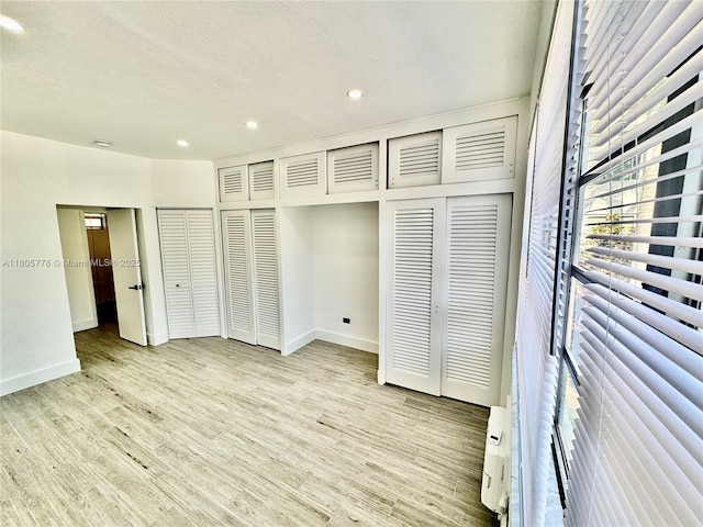 4710 Pine Tree Dr Unit 31, Miami Beach, FL 33140 - unfurnished bedroom with baseboards, light wood-style flooring, and recessed lighting