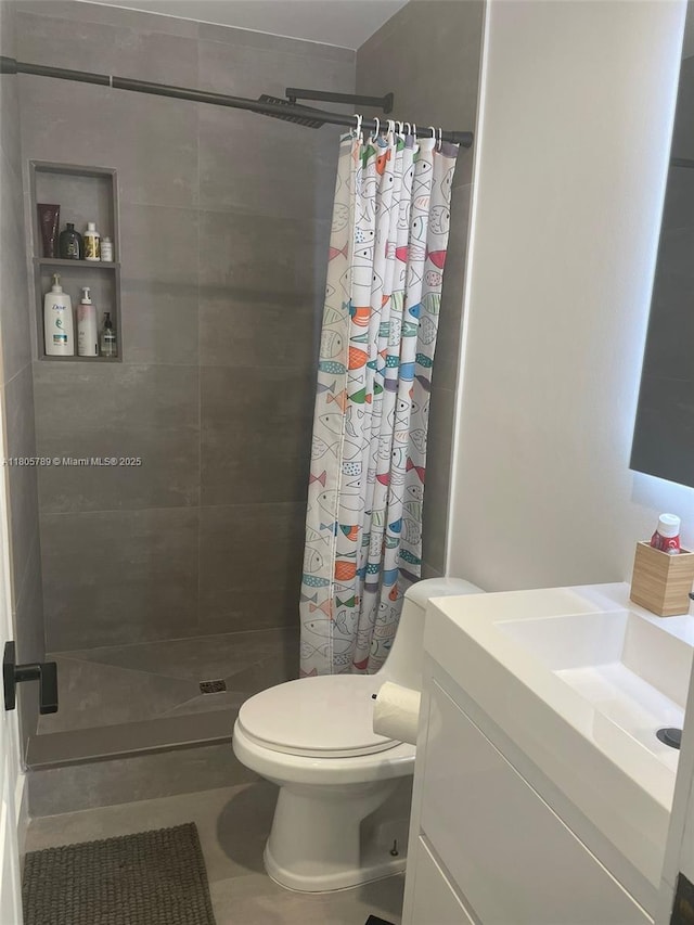 3720 NE 167th St Unit 39, North Miami Beach, FL 33160 - bathroom featuring a stall shower, toilet, vanity, and tile patterned flooring