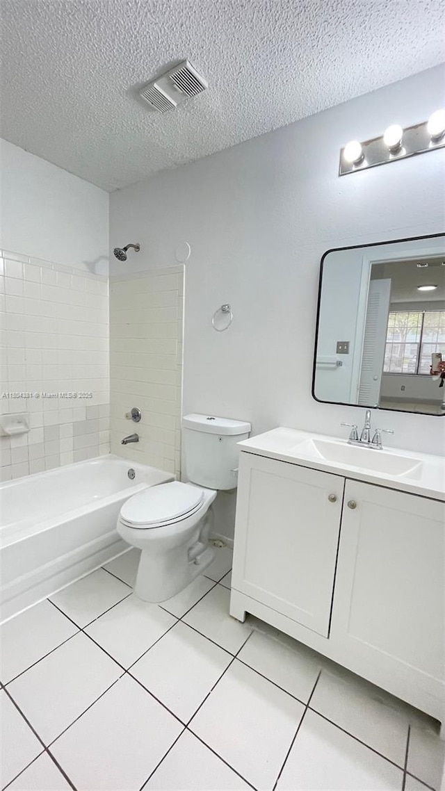 full bath featuring tile patterned floors, toilet, a textured ceiling, bathing tub / shower combination, and vanity