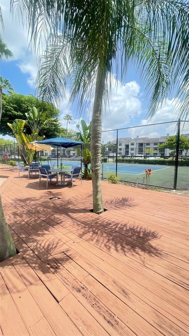 view of community featuring a tennis court