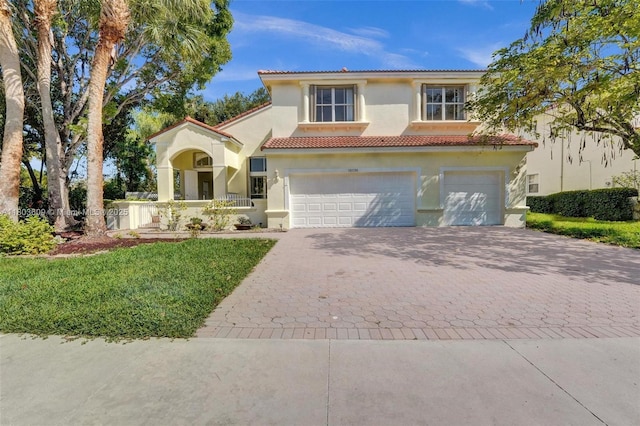 10730 NW 56th Ct, Coral Springs, FL 33076 - mediterranean / spanish home with decorative driveway, an attached garage, stucco siding, a tiled roof, and a front lawn