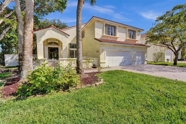 10730 NW 56th Ct, Coral Springs, FL 33076 - mediterranean / spanish-style house with a tile roof, an attached garage, driveway, stucco siding, and a front lawn