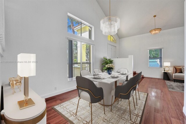 10730 NW 56th Ct, Coral Springs, FL 33076 - dining area featuring high vaulted ceiling, wood finished floors, and a chandelier