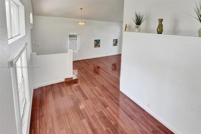 10730 NW 56th Ct, Coral Springs, FL 33076 - empty room featuring wood finished floors and vaulted ceiling