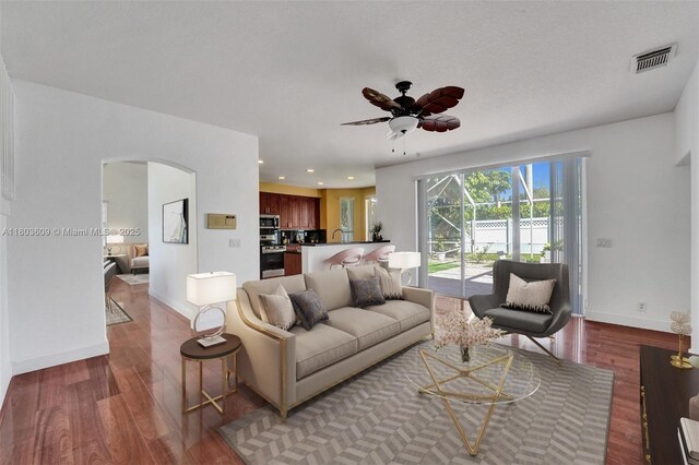 10730 NW 56th Ct, Coral Springs, FL 33076 - living room with arched walkways, wood finished floors, a ceiling fan, and recessed lighting