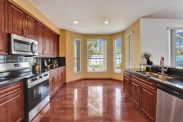 10730 NW 56th Ct, Coral Springs, FL 33076 - kitchen featuring appliances with stainless steel finishes, healthy amount of natural light, recessed lighting, dark wood finished floors, and a textured ceiling