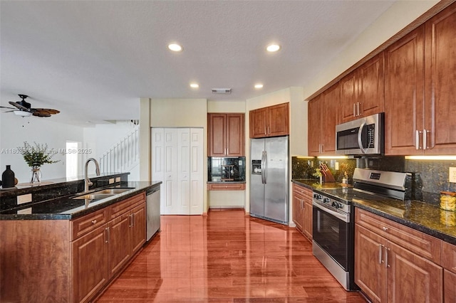 10730 NW 56th Ct, Coral Springs, FL 33076 - kitchen featuring appliances with stainless steel finishes, backsplash, brown cabinets, recessed lighting, and ceiling fan
