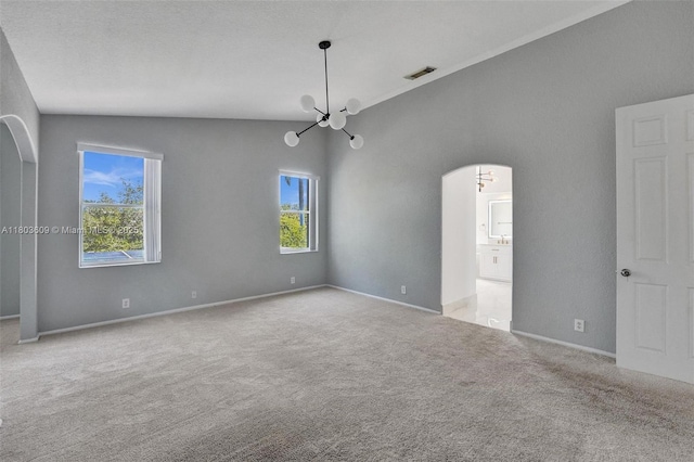 10730 NW 56th Ct, Coral Springs, FL 33076 - carpeted spare room featuring a chandelier, arched walkways, plenty of natural light, and vaulted ceiling