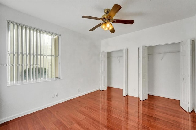 10730 NW 56th Ct, Coral Springs, FL 33076 - unfurnished bedroom featuring wood finished floors, multiple closets, and a ceiling fan