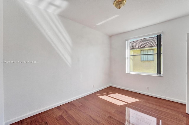 10730 NW 56th Ct, Coral Springs, FL 33076 - empty room with wood finished floors and baseboards