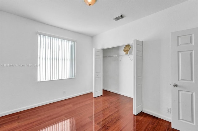 10730 NW 56th Ct, Coral Springs, FL 33076 - unfurnished bedroom featuring a closet and wood finished floors