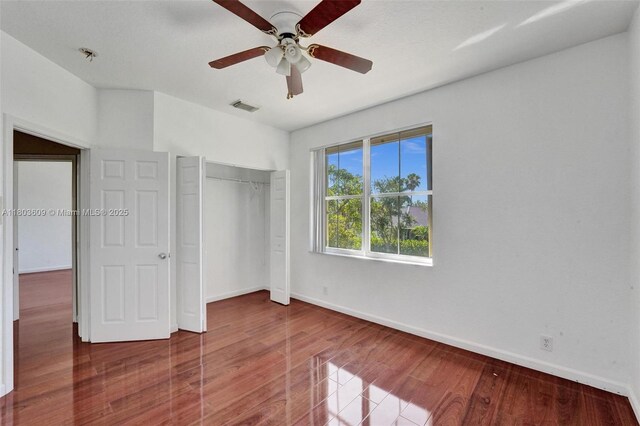 10730 NW 56th Ct, Coral Springs, FL 33076 - unfurnished bedroom featuring wood finished floors, a closet, and a ceiling fan
