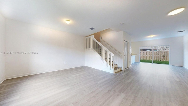 388 NW 12th Pl Unit 388, Florida City, FL 33034 - unfurnished living room featuring wood finished floors, stairway, and baseboards