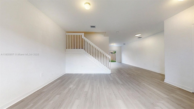 388 NW 12th Pl Unit 388, Florida City, FL 33034 - unfurnished living room featuring wood finished floors, stairs, and baseboards