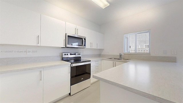 388 NW 12th Pl Unit 388, Florida City, FL 33034 - kitchen featuring appliances with stainless steel finishes, a sink, white cabinetry, and light countertops