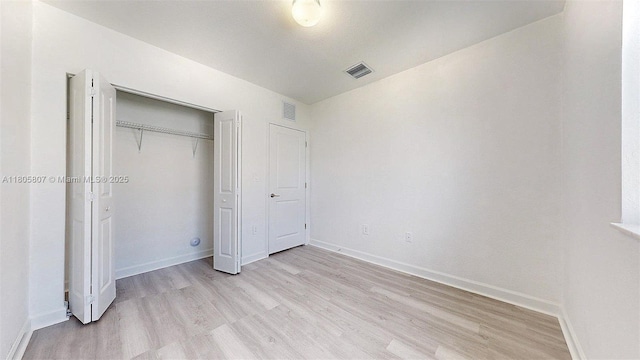 388 NW 12th Pl Unit 388, Florida City, FL 33034 - unfurnished bedroom with light wood-style flooring, baseboards, and a closet