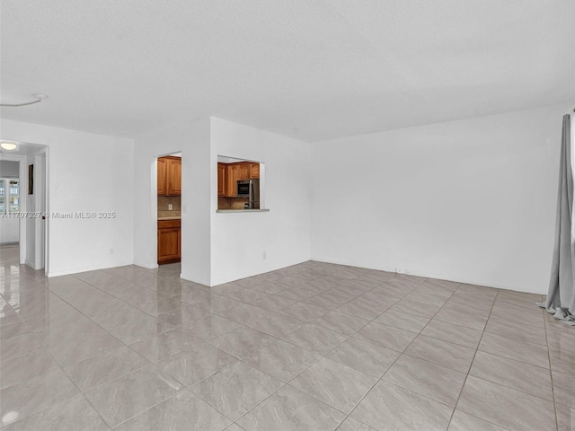 374 Tilford R Unit 374, Deerfield Beach, FL 33442 - unfurnished living room with a textured ceiling and light tile patterned floors