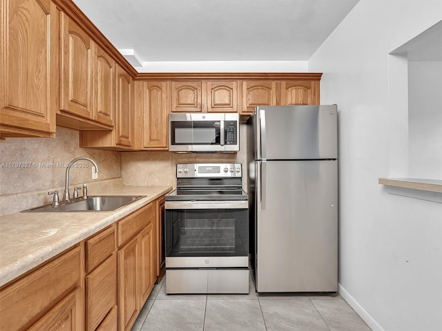 374 Tilford R Unit 374, Deerfield Beach, FL 33442 - kitchen with stainless steel appliances, a sink, tasteful backsplash, light countertops, and light tile patterned flooring