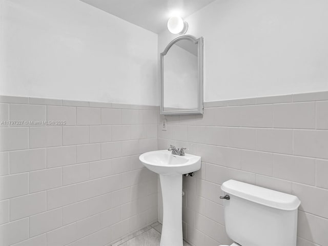 374 Tilford R Unit 374, Deerfield Beach, FL 33442 - half bath featuring toilet, wainscoting, tile walls, and a sink