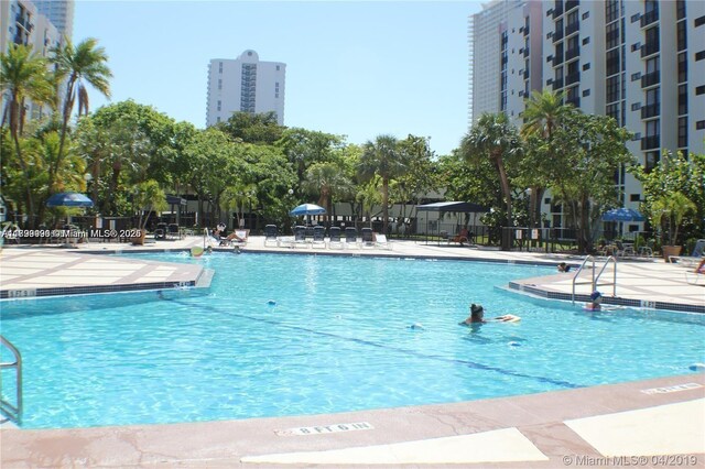 17021 N Bay Rd Unit 105, Sunny Isles Beach, FL 33160 - community pool featuring a patio
