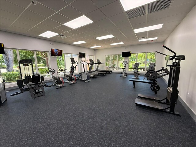 17021 N Bay Rd Unit 105, Sunny Isles Beach, FL 33160 - workout area featuring healthy amount of natural light and a drop ceiling