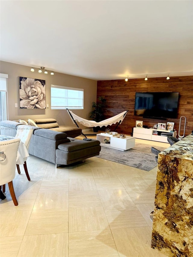 800 NE 195th St Unit 720, Miami, FL 33179 - living room featuring wood walls, track lighting, and an accent wall