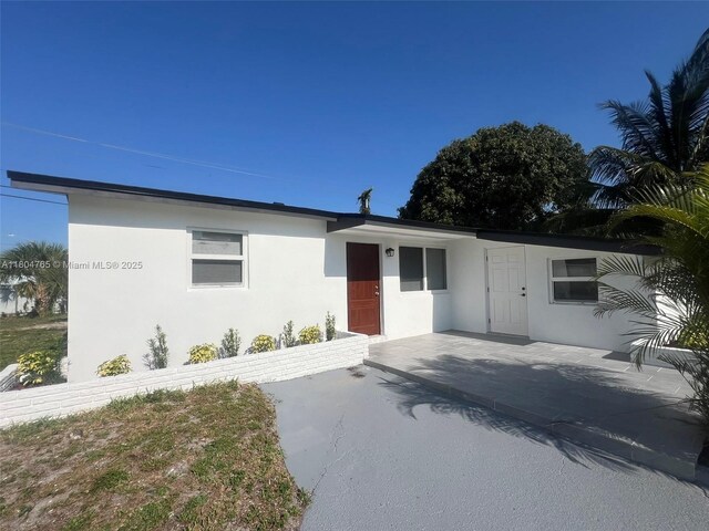 18740 NW 42nd Pl, Miami Gardens, FL 33055 - ranch-style house with stucco siding and a patio area