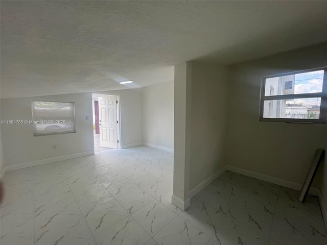 18740 NW 42nd Pl, Miami Gardens, FL 33055 - spare room featuring light marble finish floors, baseboards, and a textured ceiling