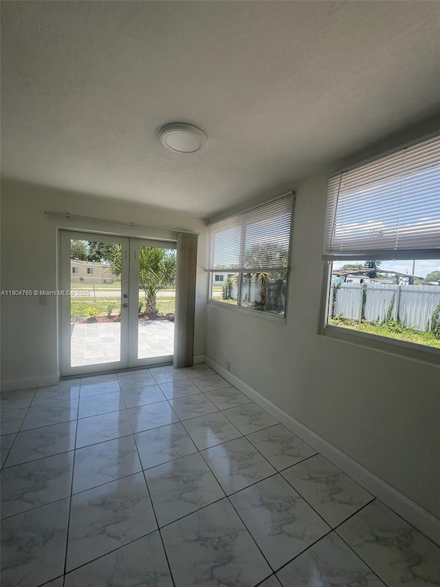 18740 NW 42nd Pl, Miami Gardens, FL 33055 - unfurnished room with light marble finish flooring, baseboards, and french doors