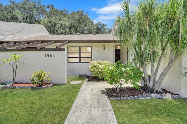 1561 NW 98th Ter, Pembroke Pines, FL 33024 - view of front of house featuring a front yard, stucco siding, and a shingled roof
