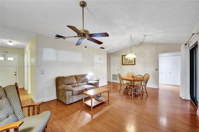 1561 NW 98th Ter, Pembroke Pines, FL 33024 - living area featuring wood finished floors, baseboards, a textured ceiling, lofted ceiling, and a ceiling fan