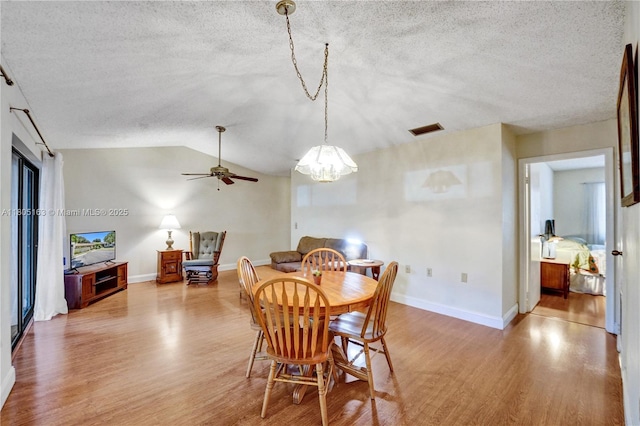 1561 NW 98th Ter, Pembroke Pines, FL 33024 - dining area featuring light wood-type flooring, a textured ceiling, vaulted ceiling, baseboards, and a chandelier