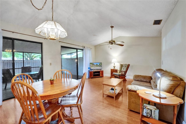 1561 NW 98th Ter, Pembroke Pines, FL 33024 - dining room with light wood-style flooring, a ceiling fan, vaulted ceiling, a chandelier, and baseboards