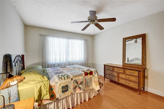 1561 NW 98th Ter, Pembroke Pines, FL 33024 - bedroom with light wood-style floors, a textured ceiling, baseboards, and a ceiling fan