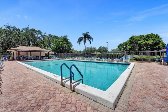 1561 NW 98th Ter, Pembroke Pines, FL 33024 - community pool featuring fence and a patio