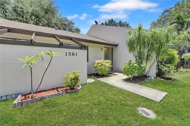 1561 NW 98th Ter, Pembroke Pines, FL 33024 - view of front of property with a front lawn, stucco siding, and roof with shingles