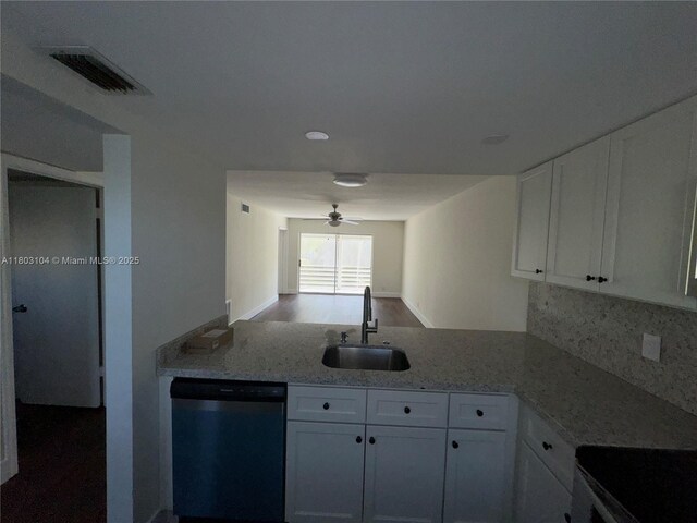 3776 Inverrary Blvd Unit 207R, Lauderhill, FL 33319 - kitchen featuring dishwashing machine, a sink, white cabinets, decorative backsplash, and light stone countertops