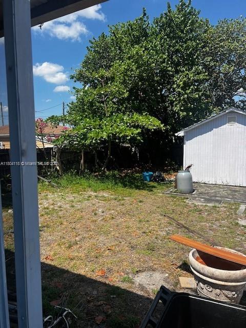 707 N J St, Lake Worth, FL 33460 - view of yard featuring an outbuilding and a storage unit