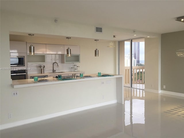 19707 Turnberry Way Unit 18D, Aventura, FL 33180 - kitchen with appliances with stainless steel finishes, a sink, floor to ceiling windows, light countertops, and tasteful backsplash