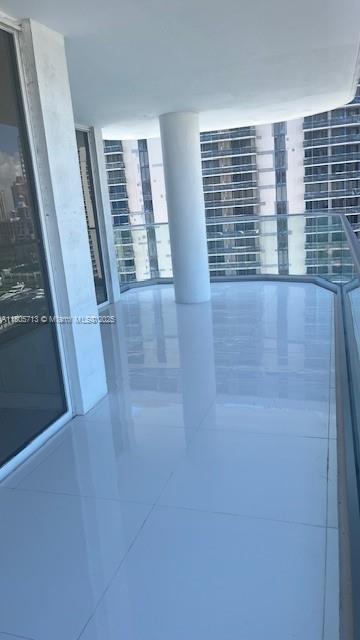 19707 Turnberry Way Unit 18D, Aventura, FL 33180 - corridor with tile patterned flooring
