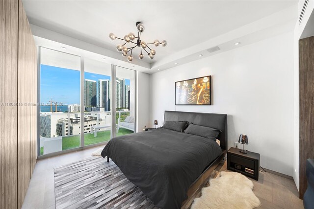 3470 E Coast Ave Unit H1201, Miami, FL 33137 - bedroom with access to outside, a chandelier, a city view, and recessed lighting