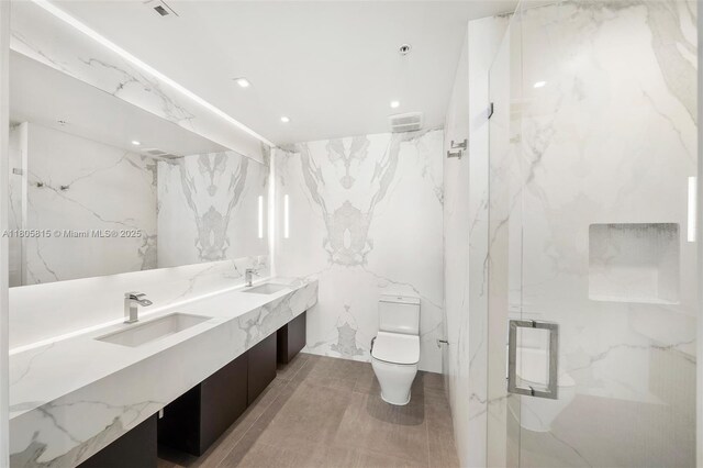3470 E Coast Ave Unit H1201, Miami, FL 33137 - bathroom featuring stone wall, toilet, a marble finish shower, double vanity, and recessed lighting