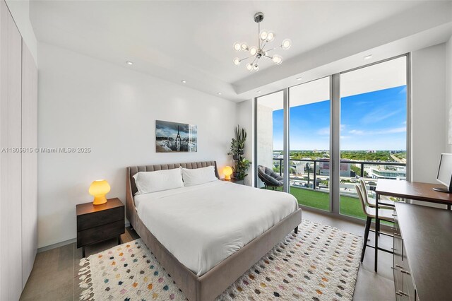3470 E Coast Ave Unit H1201, Miami, FL 33137 - bedroom with a chandelier, recessed lighting, access to exterior, and expansive windows